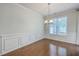 An elegant dining room with decorative wall panels, hardwood floors, and a chandelier at 3367 Eastman Dr, Mount Pleasant, SC 29466