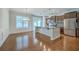 An open concept kitchen with stainless steel appliances, a granite countertop island, and beautiful hardwood floors at 3367 Eastman Dr, Mount Pleasant, SC 29466
