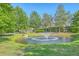 Scenic pond with a fountain, surrounded by green grass and mature trees at 3367 Eastman Dr, Mount Pleasant, SC 29466