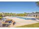 Community pool with picnic tables, lounge chairs, and palm trees in the background at 3367 Eastman Dr, Mount Pleasant, SC 29466