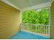 Outdoor balcony with painted wood floor and railing overlooking lush green trees at 3517 Claremont St, Mount Pleasant, SC 29466