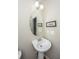 Cozy bathroom features a pedestal sink, oval mirror, and neutral wall color at 3517 Claremont St, Mount Pleasant, SC 29466