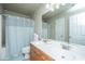 Bright bathroom featuring a double sink vanity, shower with curtain and an ample mirror at 3517 Claremont St, Mount Pleasant, SC 29466