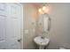 Clean bathroom features a pedestal sink, round mirror, and classic lighting fixtures at 3517 Claremont St, Mount Pleasant, SC 29466