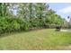 Spacious backyard with a wooden fence, mature trees and green lawn at 3537 Galaxy Rd, Ladson, SC 29456