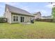 Spacious backyard featuring a well-maintained lawn, patio area, and a wood privacy fence at 3537 Galaxy Rd, Ladson, SC 29456