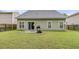 Backyard featuring a grill on a concrete patio, lawn, and a wood fence for privacy at 3537 Galaxy Rd, Ladson, SC 29456