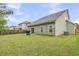 View of the backyard with a well-maintained lawn, privacy fence, and a concrete patio at 3537 Galaxy Rd, Ladson, SC 29456