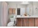 Bathroom showcasing a double sink vanity with wood cabinets, a toilet, and a shower with colorful curtain at 3537 Galaxy Rd, Ladson, SC 29456