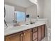 Bathroom featuring double sinks with elegant vanity, large mirror, and a glass block window for natural light at 3537 Galaxy Rd, Ladson, SC 29456