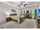 Inviting bedroom with tray ceiling, ceiling fan, and large windows allowing natural light at 3537 Galaxy Rd, Ladson, SC 29456