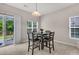 Bright breakfast nook with a view of the backyard from the sliding glass door and windows at 3537 Galaxy Rd, Ladson, SC 29456