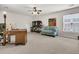 Spacious bonus room with neutral walls, ceiling fan, and a plush blue sofa at 3537 Galaxy Rd, Ladson, SC 29456