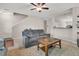 Relaxing living room featuring a plush sofa, area rug, and open staircase at 3537 Galaxy Rd, Ladson, SC 29456
