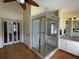Bright bathroom with a walk-in shower, wood floors, double doors and updated vanity at 36 Forde Row, Charleston, SC 29412