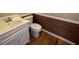 Small, yet stylish bathroom with wood paneling and a white vanity at 36 Forde Row, Charleston, SC 29412