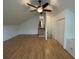 Bedroom with vaulted ceiling, hardwood floors, closet, stairs, and bright natural light through shuttered windows at 36 Forde Row, Charleston, SC 29412