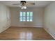 Bedroom with a ceiling fan, plantation shutters, and wood floors at 36 Forde Row, Charleston, SC 29412