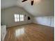 Bedroom with vaulted ceiling, hardwood floors, bright natural light through shuttered windows and built in storage at 36 Forde Row, Charleston, SC 29412