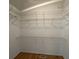 Walk-in closet with metal shelving and wood floors at 36 Forde Row, Charleston, SC 29412