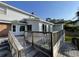 Exterior view of home showcasing a wooden deck with railings, light gray siding, and brick accents at 36 Forde Row, Charleston, SC 29412