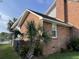 Brick home's side exterior shows a black roof with a landscaped yard including a palm tree at 36 Forde Row, Charleston, SC 29412