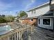 Exterior of house featuring a wooden deck, swimming pool, brick facade, and light gray siding at 36 Forde Row, Charleston, SC 29412