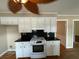 Modern kitchen with white cabinetry, black countertops, and stainless steel oven range at 36 Forde Row, Charleston, SC 29412