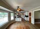 Open kitchen area with white cabinets, black countertops, wooden floors, and lake view at 36 Forde Row, Charleston, SC 29412
