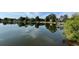 Picturesque lake view from the shoreline, featuring calm waters, trees, and residential homes at 36 Forde Row, Charleston, SC 29412