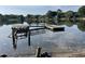 Picturesque lake view featuring wooden docks, clear skies, and reflection of trees at 36 Forde Row, Charleston, SC 29412