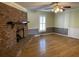 Cozy living room with a brick fireplace, hardwood floors, and natural light at 36 Forde Row, Charleston, SC 29412