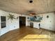Bright living room with a wet bar, hardwood floors, and unique tropical-themed wall art at 36 Forde Row, Charleston, SC 29412