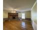 Inviting living room with a classic brick fireplace, hardwood floors, and neutral walls at 36 Forde Row, Charleston, SC 29412