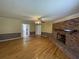 Open-concept living room with brick fireplace, wood floors, and natural light at 36 Forde Row, Charleston, SC 29412