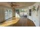 Light-filled living room with water views, hardwood floors, and unique tropical wall murals at 36 Forde Row, Charleston, SC 29412