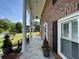 Covered front porch showcasing stately columns and outdoor seating at 36 Forde Row, Charleston, SC 29412