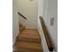 Stairway with wooden handrail and light-colored wooden steps at 36 Forde Row, Charleston, SC 29412