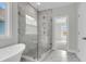 Bathroom showcasing a glass enclosed shower, marble tile, and entry to an adjacent room at 389 Wappoo Trace Ln, Summerville, SC 29486