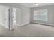 Bright bedroom with plush carpet, two windows, and an open doorway to other rooms, great for relaxing at 389 Wappoo Trace Ln, Summerville, SC 29486