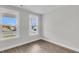 A bedroom features hardwood floors, two large windows overlooking green outdoor views at 389 Wappoo Trace Ln, Summerville, SC 29486