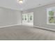 A bright bedroom with carpet, recessed lights, crown molding, and natural light, offering a relaxing space at 389 Wappoo Trace Ln, Summerville, SC 29486