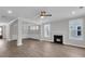 Open-concept living room with a fireplace, ceiling fan, and dining area at 389 Wappoo Trace Ln, Summerville, SC 29486
