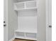 A convenient mudroom featuring a white built-in bench, cubbies, and shelving for organized storage near the entry at 389 Wappoo Trace Ln, Summerville, SC 29486
