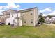 Green backyard of a townhome with air conditioning and a view of neighborhood at 394 Flyway Rd, Goose Creek, SC 29445