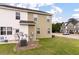 Green backyard of a townhome with air conditioning and a satellite dish at 394 Flyway Rd, Goose Creek, SC 29445
