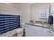 Bathroom with granite countertop and sink, toilet, and shower with blue and white curtain at 394 Flyway Rd, Goose Creek, SC 29445