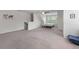 Spacious carpeted bedroom with a ceiling fan, a small bed and a staircase to another level at 394 Flyway Rd, Goose Creek, SC 29445