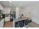 Bright kitchen with a large island featuring barstool seating, stainless steel appliances, and white cabinetry at 394 Flyway Rd, Goose Creek, SC 29445