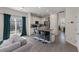Open kitchen with black island, white cabinets, and stainless steel appliances at 394 Flyway Rd, Goose Creek, SC 29445